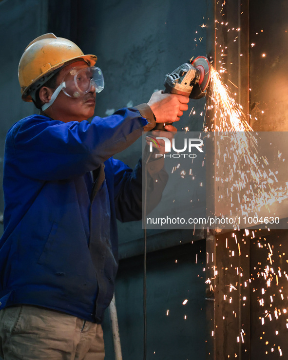 A worker is grinding at the production workshop of Nanjing Changjiang Industrial Furnace Technology Group Co., Ltd. in Nanjing, Jiangsu Prov...