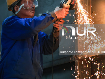 A worker is grinding at the production workshop of Nanjing Changjiang Industrial Furnace Technology Group Co., Ltd. in Nanjing, Jiangsu Prov...