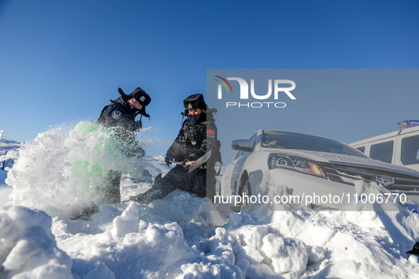 Border police are rescuing a stranded vehicle in Altay, Xinjiang province, China, on February 18, 2024, as the lowest temperature reaches -5...