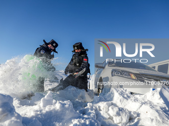 Border police are rescuing a stranded vehicle in Altay, Xinjiang province, China, on February 18, 2024, as the lowest temperature reaches -5...