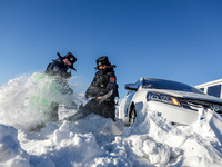 Border police are rescuing a stranded vehicle in Altay, Xinjiang province, China, on February 18, 2024, as the lowest temperature reaches -5...