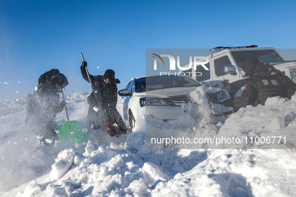 Border police are rescuing a stranded vehicle in Altay, Xinjiang province, China, on February 18, 2024, as the lowest temperature reaches -5...