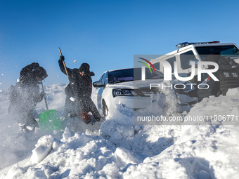 Border police are rescuing a stranded vehicle in Altay, Xinjiang province, China, on February 18, 2024, as the lowest temperature reaches -5...