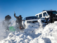 Border police are rescuing a stranded vehicle in Altay, Xinjiang province, China, on February 18, 2024, as the lowest temperature reaches -5...