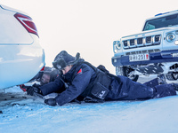 Border police are rescuing a stranded vehicle in Altay, Xinjiang province, China, on February 18, 2024, as the lowest temperature reaches -5...