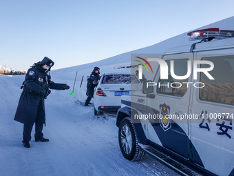 Border police are rescuing a stranded vehicle in Altay, Xinjiang province, China, on February 18, 2024, as the lowest temperature reaches -5...