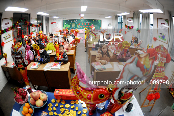 Students are waiting to receive new textbooks in a classroom of the second grade at Yuanqian Primary School in Lianyungang, China, on Februa...