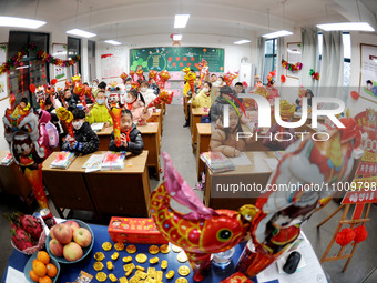 Students are waiting to receive new textbooks in a classroom of the second grade at Yuanqian Primary School in Lianyungang, China, on Februa...