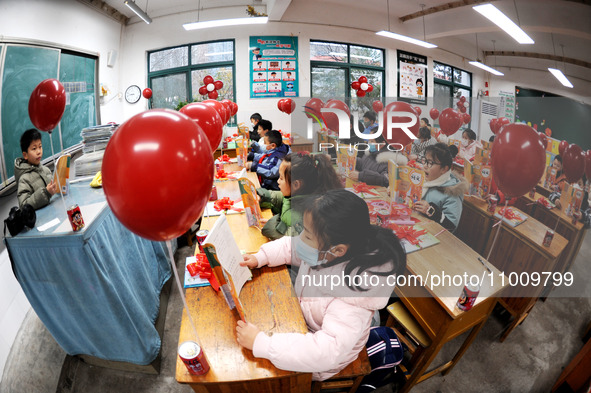 Students are waiting to receive new textbooks in a classroom of the second grade at Yuanqian Primary School in Lianyungang, China, on Februa...