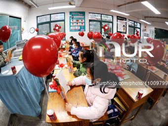 Students are waiting to receive new textbooks in a classroom of the second grade at Yuanqian Primary School in Lianyungang, China, on Februa...