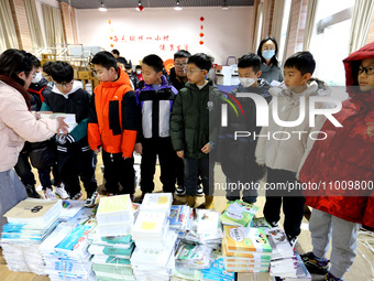 Students are receiving new textbooks at Yuanqian Primary School in Lianyungang, China, on February 20, 2024. (