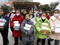 Students are receiving new textbooks at Yuanqian Primary School in Lianyungang, China, on February 20, 2024. (