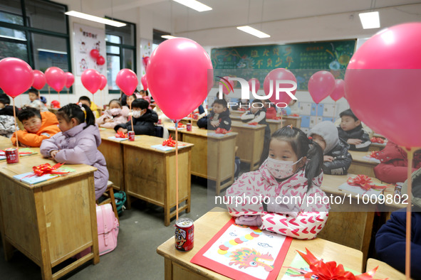 Students are waiting to receive new textbooks in a classroom of the second grade at Yuanqian Primary School in Lianyungang, China, on Februa...