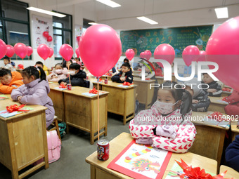 Students are waiting to receive new textbooks in a classroom of the second grade at Yuanqian Primary School in Lianyungang, China, on Februa...