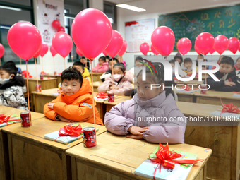 Students are waiting to receive new textbooks in a classroom of the second grade at Yuanqian Primary School in Lianyungang, China, on Februa...