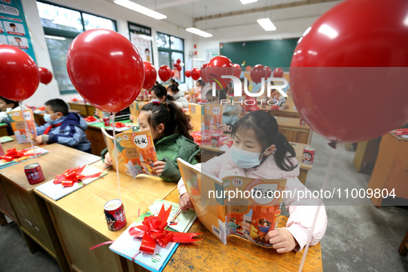 Students are reading new textbooks they have just received in a classroom of the second grade at Yuanqian Primary School in Lianyungang, Chi...