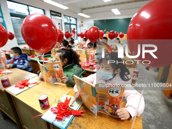 Students are reading new textbooks they have just received in a classroom of the second grade at Yuanqian Primary School in Lianyungang, Chi...