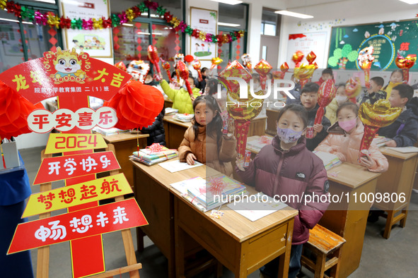 Students are waiting to receive new textbooks in a classroom of the second grade at Yuanqian Primary School in Lianyungang, China, on Februa...