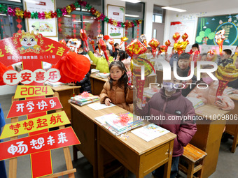 Students are waiting to receive new textbooks in a classroom of the second grade at Yuanqian Primary School in Lianyungang, China, on Februa...