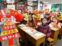 Students are waiting to receive new textbooks in a classroom of the second grade at Yuanqian Primary School in Lianyungang, China, on Februa...