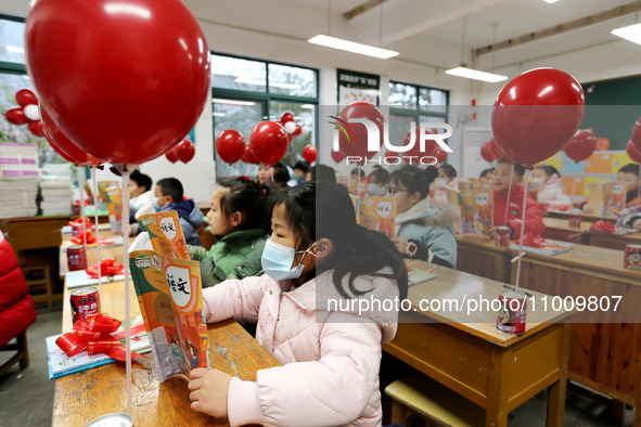 Students are reading new textbooks they have just received in a classroom of the second grade at Yuanqian Primary School in Lianyungang, Chi...