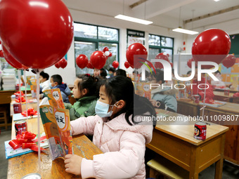 Students are reading new textbooks they have just received in a classroom of the second grade at Yuanqian Primary School in Lianyungang, Chi...