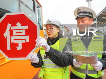 Police are conducting a safety check on a school bus at Erdu Primary School in Huzhou, China, on February 20, 2024. (