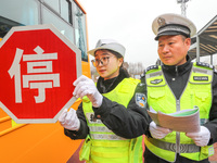 Police are conducting a safety check on a school bus at Erdu Primary School in Huzhou, China, on February 20, 2024. (