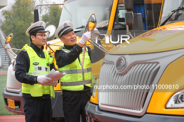 Police are conducting a safety check on a school bus at Erdu Primary School in Huzhou, China, on February 20, 2024. 