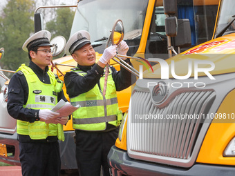 Police are conducting a safety check on a school bus at Erdu Primary School in Huzhou, China, on February 20, 2024. (