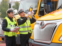 Police are conducting a safety check on a school bus at Erdu Primary School in Huzhou, China, on February 20, 2024. (