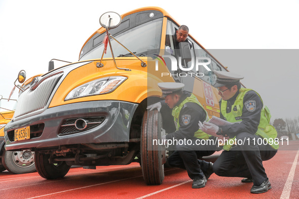 Police are conducting a safety check on a school bus at Erdu Primary School in Huzhou, China, on February 20, 2024. 