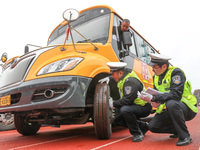 Police are conducting a safety check on a school bus at Erdu Primary School in Huzhou, China, on February 20, 2024. (