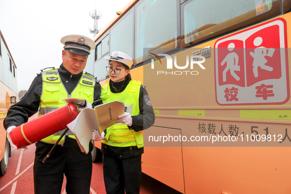 Police are conducting a safety check on a school bus at Erdu Primary School in Huzhou, China, on February 20, 2024. 