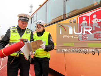 Police are conducting a safety check on a school bus at Erdu Primary School in Huzhou, China, on February 20, 2024. (