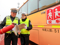 Police are conducting a safety check on a school bus at Erdu Primary School in Huzhou, China, on February 20, 2024. (