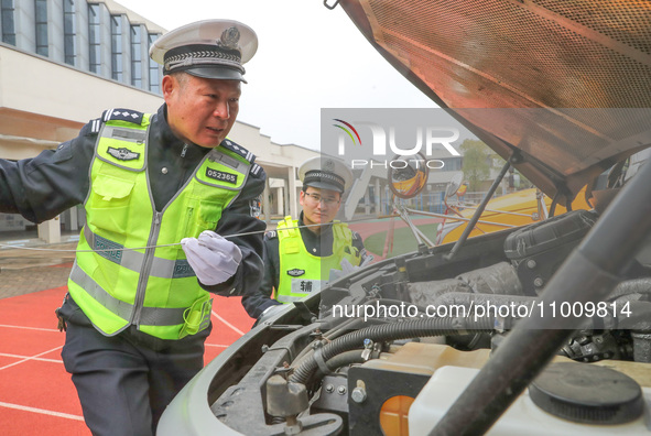 Police are conducting a safety check on a school bus at Erdu Primary School in Huzhou, China, on February 20, 2024. 