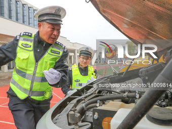 Police are conducting a safety check on a school bus at Erdu Primary School in Huzhou, China, on February 20, 2024. (