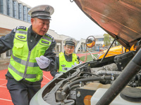 Police are conducting a safety check on a school bus at Erdu Primary School in Huzhou, China, on February 20, 2024. (