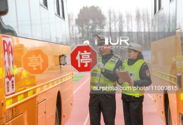 Police are conducting a safety check on a school bus at Erdu Primary School in Huzhou, China, on February 20, 2024. 