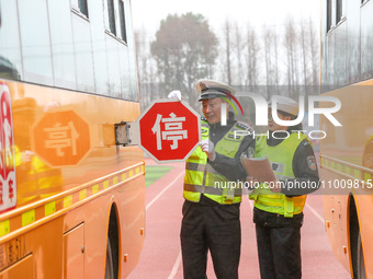 Police are conducting a safety check on a school bus at Erdu Primary School in Huzhou, China, on February 20, 2024. (