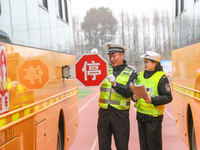 Police are conducting a safety check on a school bus at Erdu Primary School in Huzhou, China, on February 20, 2024. (