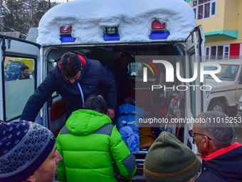 People are carrying the dead body of a skier who was killed after an avalanche struck the Ski resort in Gulmarg, Baramulla District, Indian...