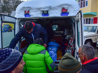 People are carrying the dead body of a skier who was killed after an avalanche struck the Ski resort in Gulmarg, Baramulla District, Indian...