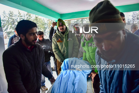 People are carrying the dead body of a skier who was killed after an avalanche struck the Ski resort in Gulmarg, Baramulla District, Indian...