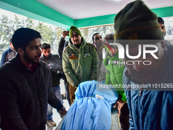 People are carrying the dead body of a skier who was killed after an avalanche struck the Ski resort in Gulmarg, Baramulla District, Indian...