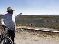 A farmer is pointing out the Zumpango Lagoon, which is affected by the drought due to the lack of rain, in Zumpango de Ocampo, Mexico, on Fe...