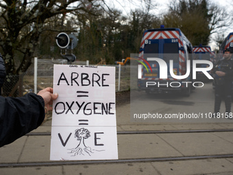 A young woman is holding a placard that reads 'Tree = Oxygen = Life' in Saix, Tarn, France, on February 22, 2024. Michel Forst, the United N...