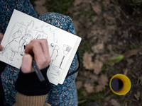 A young woman is drawing a scene near the 'Crem'Arbre' ZAD, where people are being blocked by the Gendarmerie Mobile. Michel Forst, the Unit...