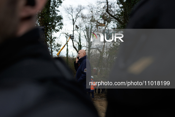 Michel Forst is speaking on the phone while policemen are arresting an 'Ecureuil' in a tree in a very dangerous situation in Saix, France, o...